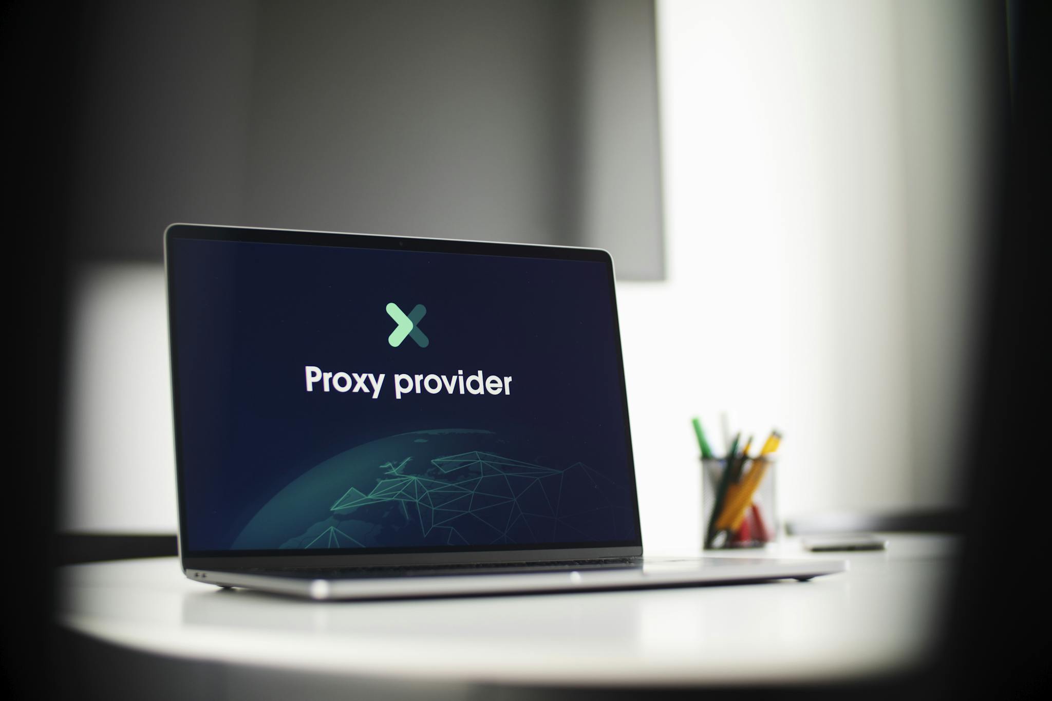 Laptop screen showing 'Proxy provider' in a tech office setting, focus on cybersecurity.